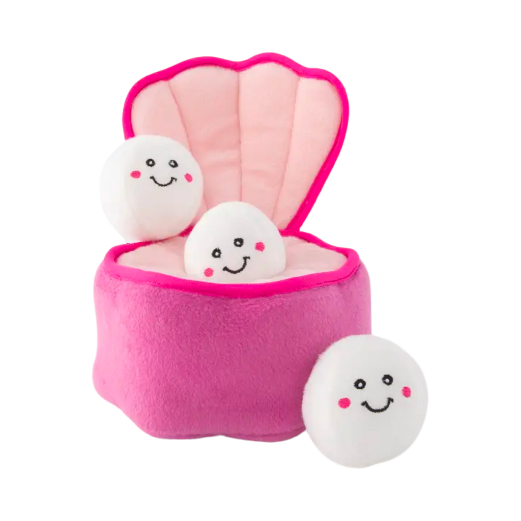 Coquille d'huître rose ouverte et trois perles souriantes