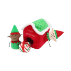 Lutin sortant de la maisonnette rouge à côté d'un cadeau rayé